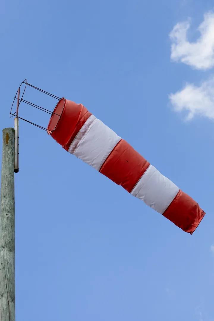 A red and white windsock blowing in the wind